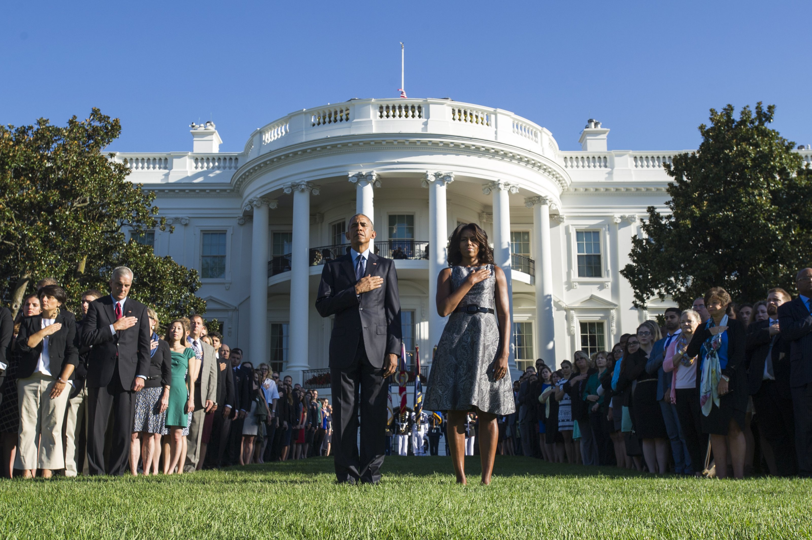President Barack Obama and First Lady Michelle Obama, joined by White House staff, stand as Taps is played on the 14th anniversary of the September 11 terrorist attacks on the United States, at the White House in Washington, D.C. on September 11, 2015. Photo by Kevin Dietsch/UPI/ABACAPRESS.COM