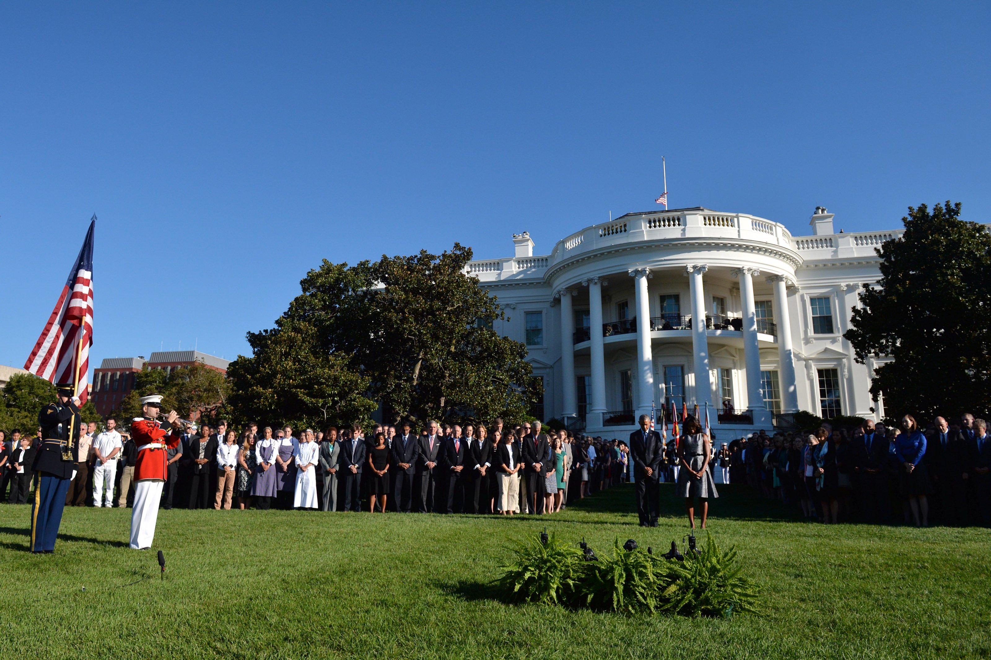 President Barack Obama and First Lady Michelle Obama, joined by White House staff, participate in a moment of silence on the 14th anniversary of the September 11 terrorist attacks on the United States, at the White House in Washington, D.C. on September 11, 2015. Photo by Kevin Dietsch/UPI/ABACAPRESS.COM