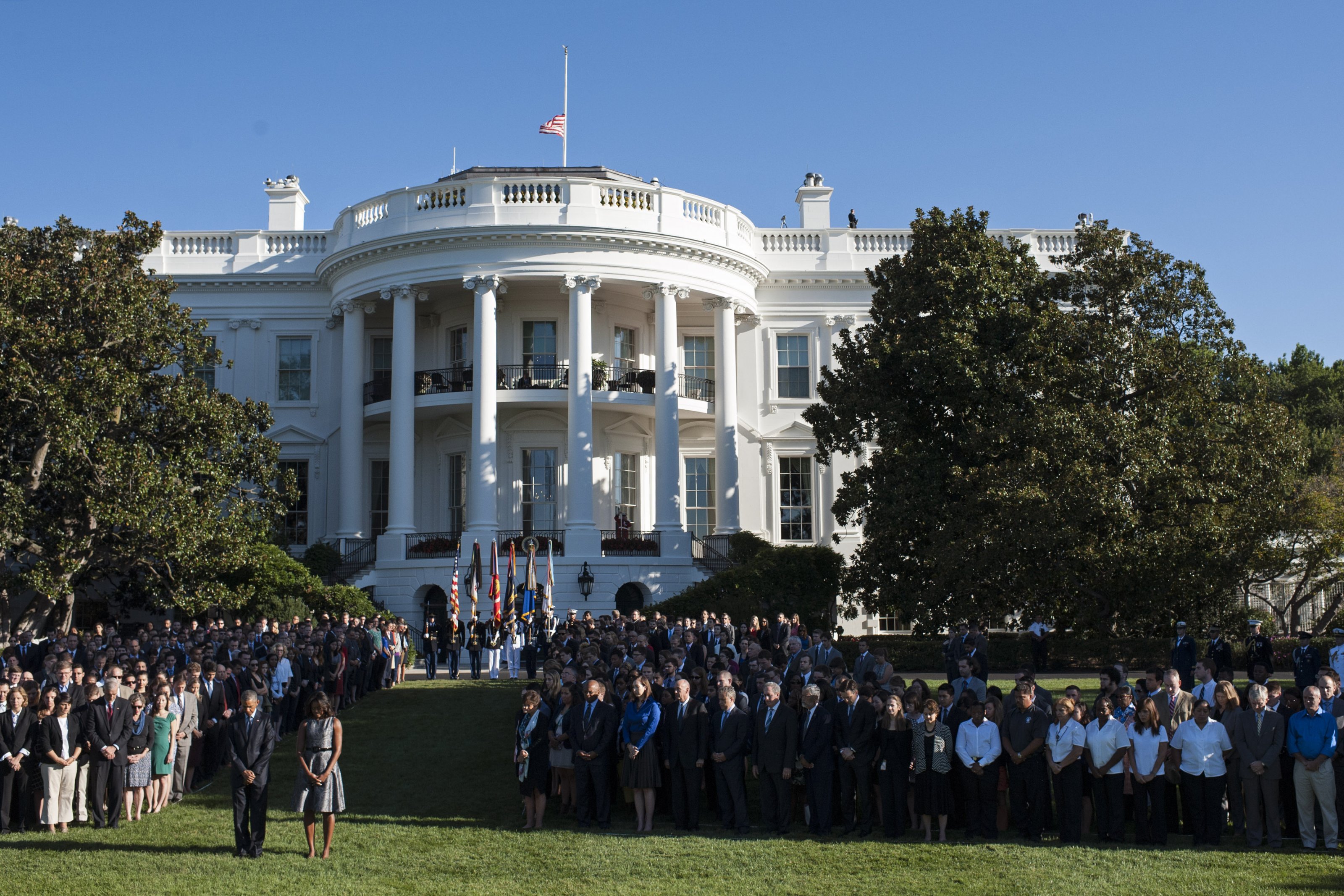 President Barack Obama and First Lady Michelle Obama, joined by White House staff, participate in a moment of silence on the 14th anniversary of the September 11 terrorist attacks on the United States, at the White House in Washington, D.C. on September 11, 2015. Photo by Kevin Dietsch/UPI/ABACAPRESS.COM